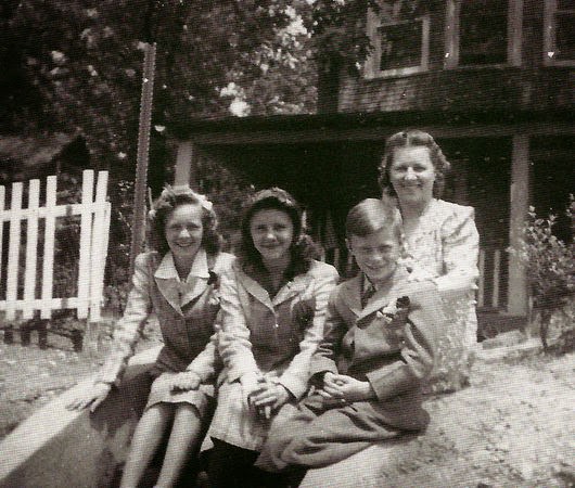 Mary Hofacker sits on the step in front of her family's home on West Fourth Avenue in Pine Hill with her children, Mary, Georgeanna and George Jr., 1943.