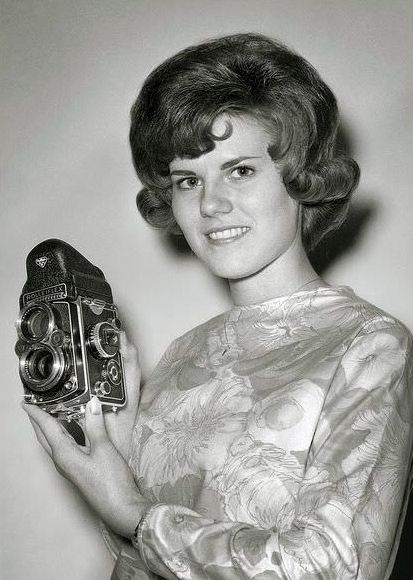 A nice looking 1960's girl shows off her nice looking Rollieflex.