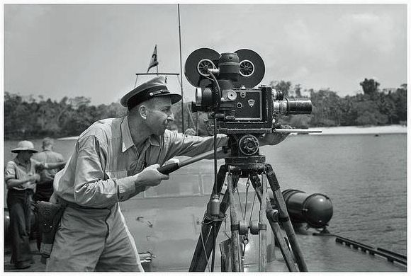 United States Navy cinematographer with a Mitchell camera on board a Motor Torpedo Boat somewhere in the Pacific during WW2.