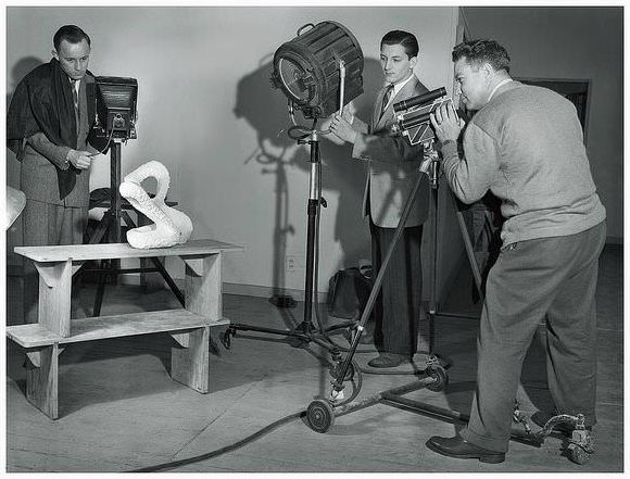 Chicago camera club photographers of the 1940's pose it up for a snapshot. The guy on the left is using a large Korona stand camera, while the fellow on the right shoots with a Cine Kodak Special.