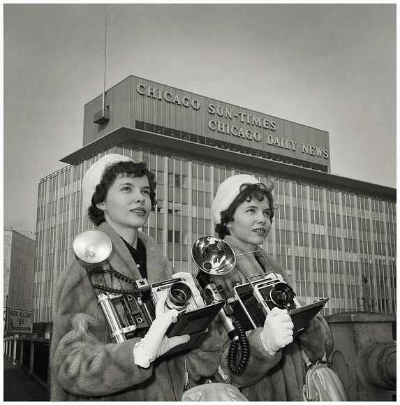 Twins, LaVona and LaVelda Rowe were press photographers for the Chicago Sun-Times Newspaper. This obviously promotional image of the ladies with their Graflex cameras was taken in February 1961.