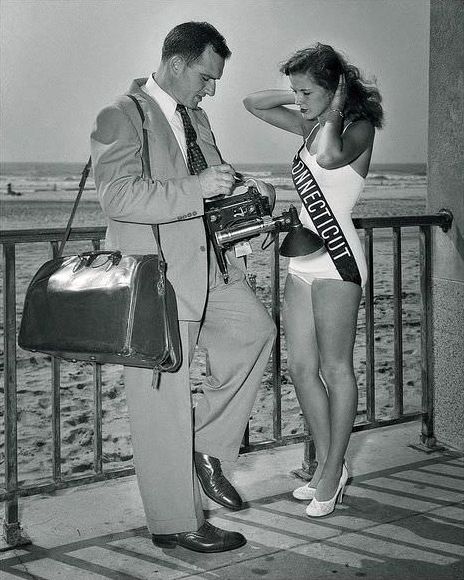 Our lucky photographer obtains details from Miss Connecticut, 19 year old Joyce Yeske, during the 1952 Miss America Pageant held in Atlantic City.