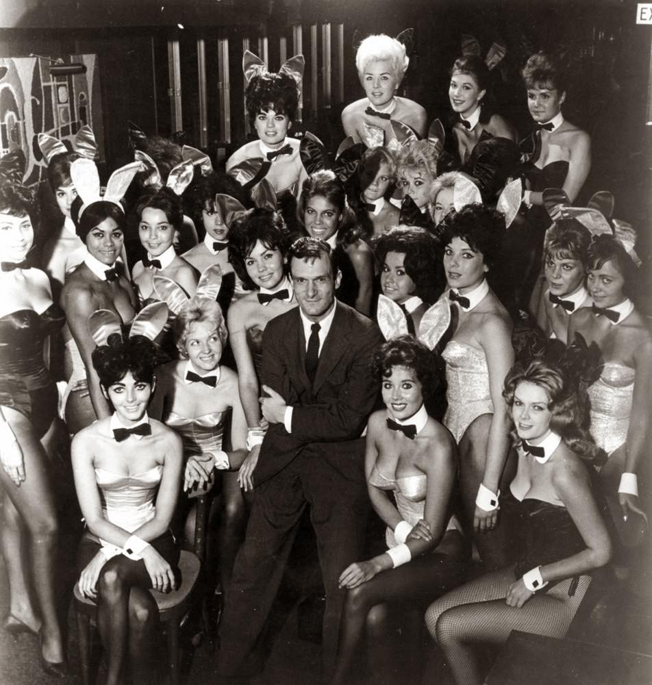 Millionaire publisher of Playboy magazine Hugh Hefner poses with a bevy of bunny girls at one of America's chain of Playboy clubs.