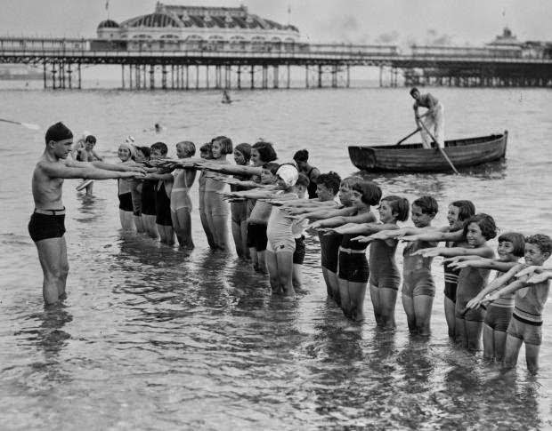 Youngsters at Brighton get their feet wet while learning proper form on August 20, 1934.