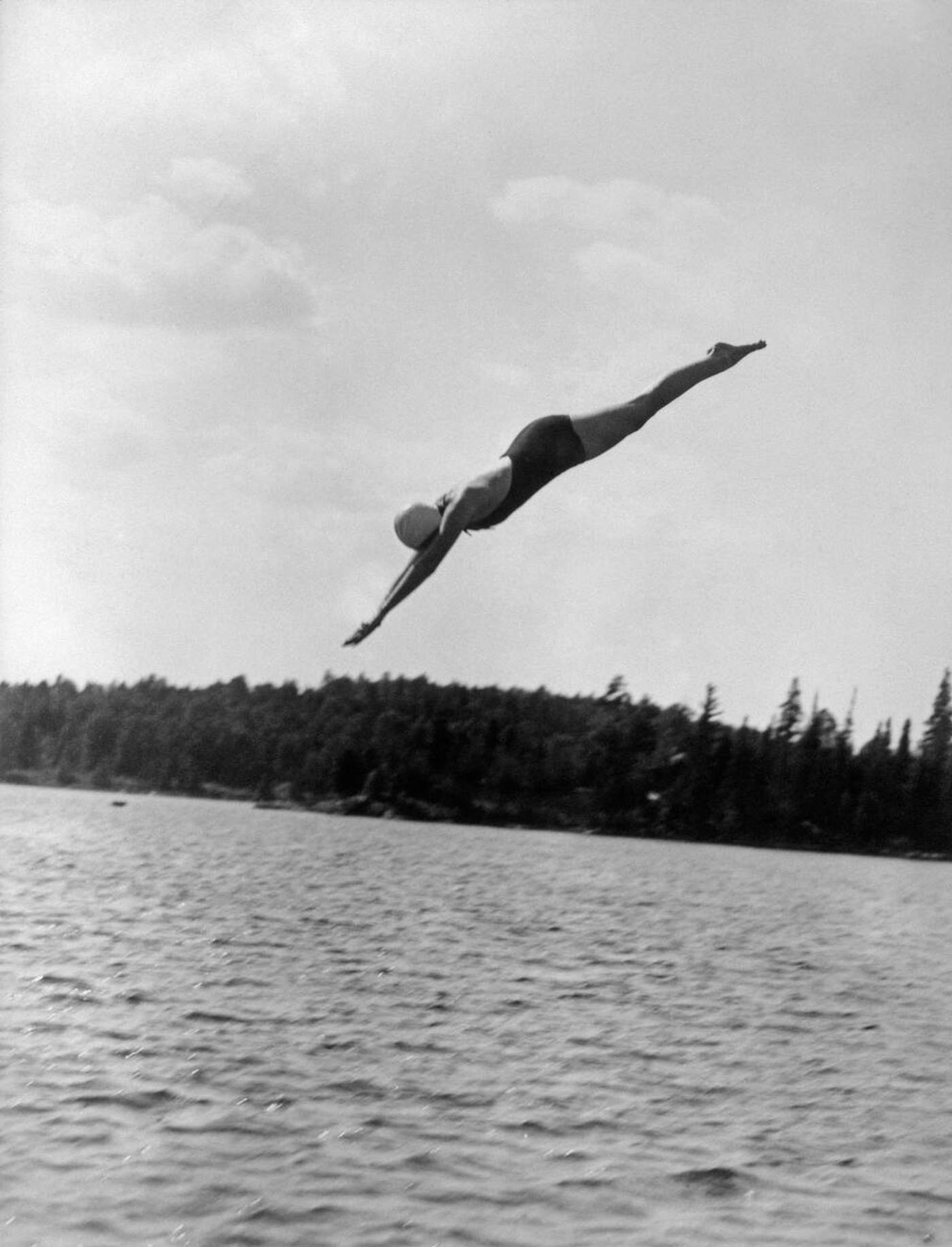 Woman diving into a lake, 1930s.