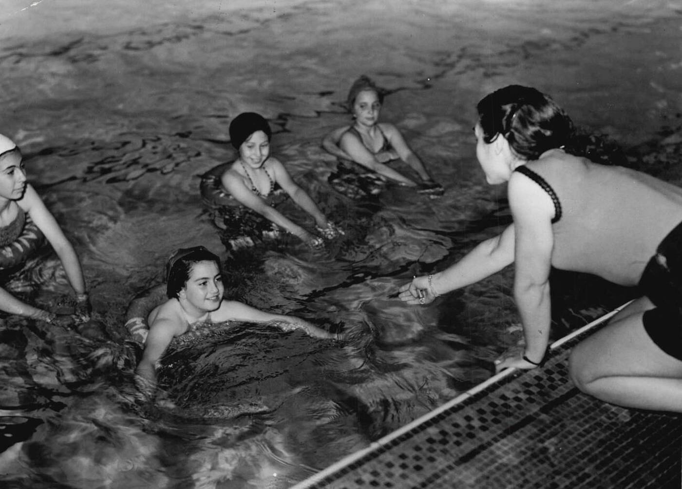 Swimming classes at the Marshall street swimming baths, All Soul's School, London; pictured left to right: Sybil Jacobvitch; Androulla Savva (Cypriot); Mary coutsarou (Cypriot); Betty Healey, 1952.