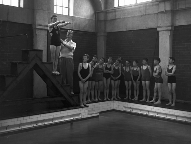 This novice swimmer is instructed on the proper form for a dive during his 1955 lesson.