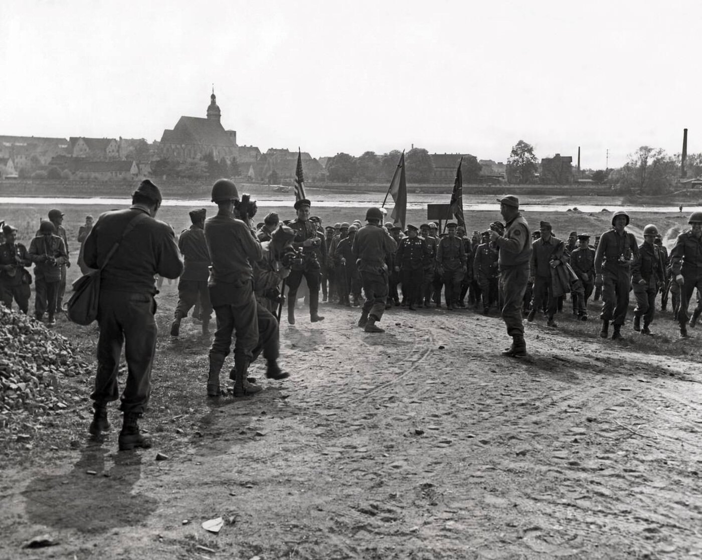 American and Russian war photographers cover a historic official meeting between U.S. First Army and Russian Army Officers on the east bank of the Elbe River in Torgau, Germany, 1945.