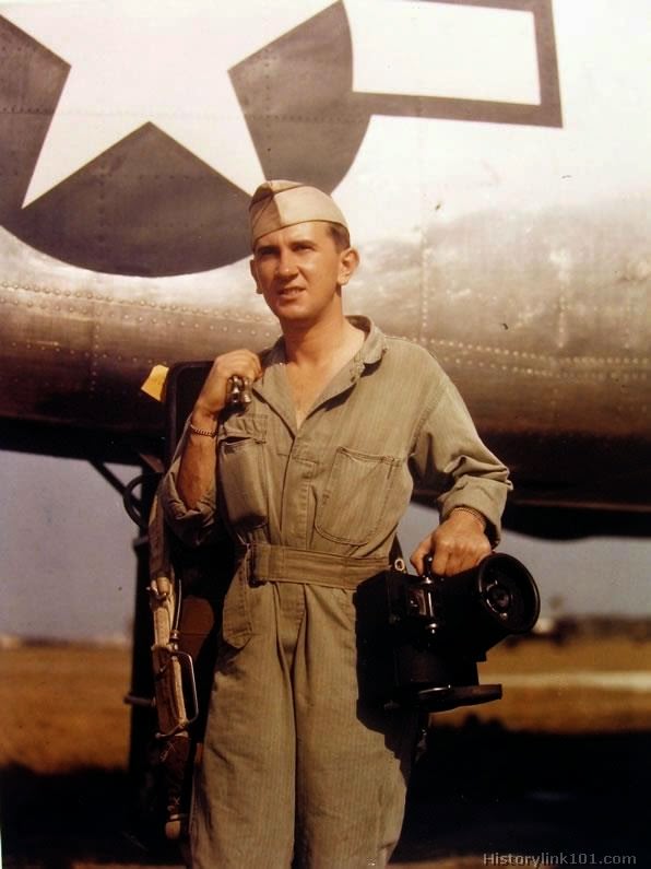 Serial photographer poses for ground photographer before boarding plane for mission.