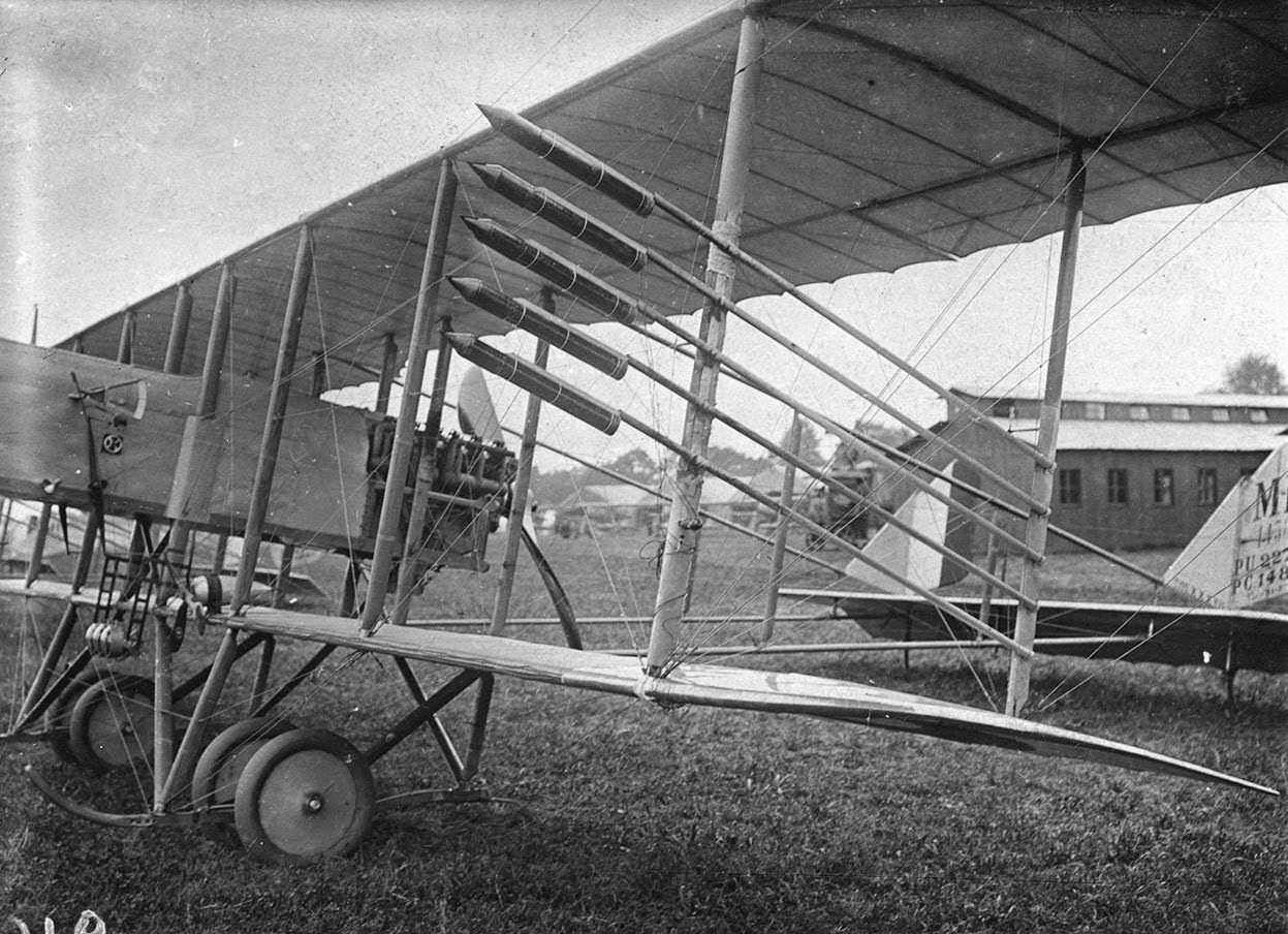 A Farman airplane with rockets attached to its struts.