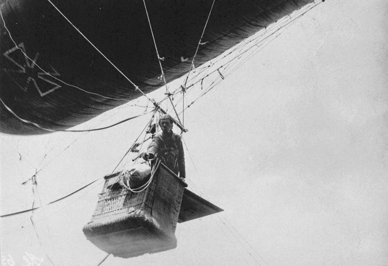 Observer in a German balloon gondola shoots off light signals with a pistol.