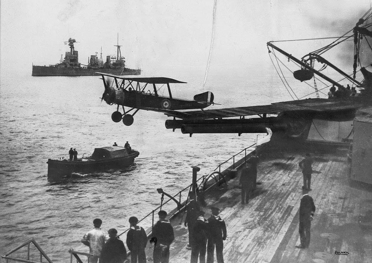 A Sopwith 1 1/2 Strutter biplane aircraft taking off from a platform built on top of HMAS Australia's midships "Q" turret, 1918.