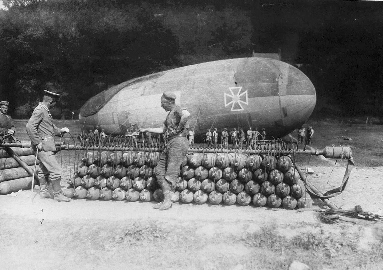German soldiers attend to a stack of gas canisters attached to a manifold, inflating a captive balloon on the Western front.