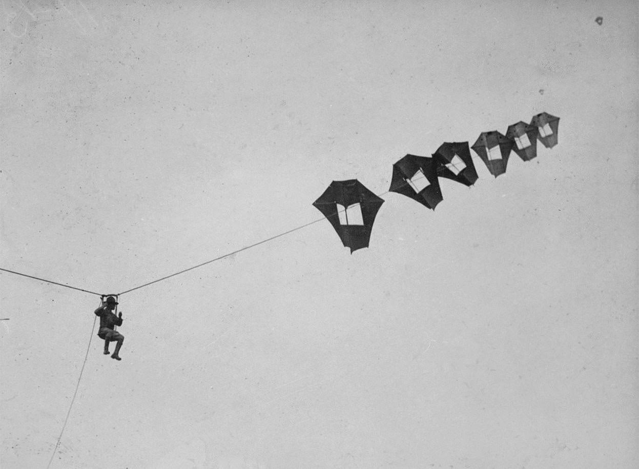Lieutenant Kirk Booth of the U.S. Signal Corps being lifted skyward by the giant Perkins man-carrying kite at Camp Devens, Ayer, Massachusetts.