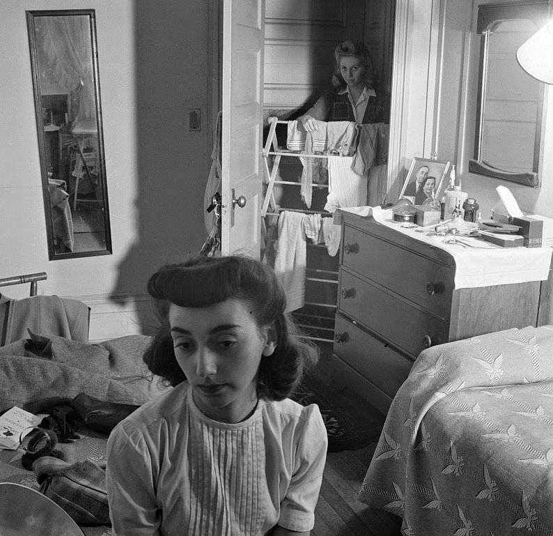 Girl in the doorway of her room at a boardinghouse