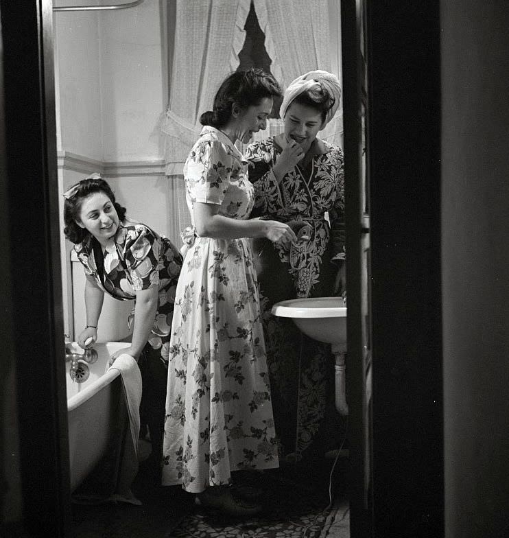 Those who are not too modest save time by tripling up in the use of the boardinghouse bathroom