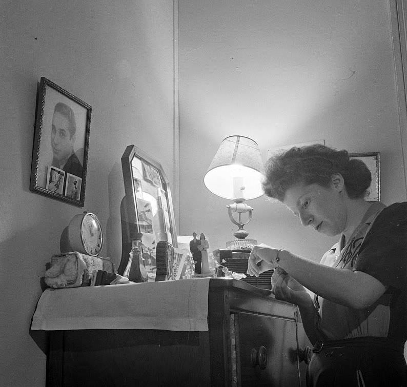 This girl met her husband at the boardinghouse. When he was drafted, she moved back into her old room. His pictures decorate the dresser and wall