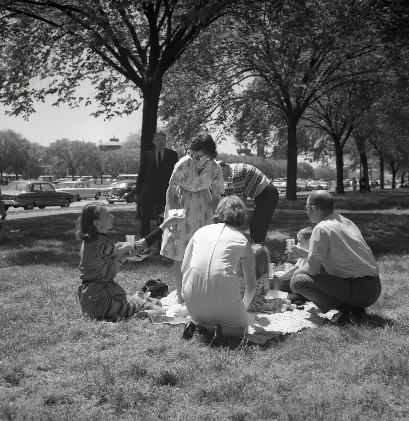 Family having a picnic in a park near the Capitol building, the home of the US Senate, Washington DC, 1950s.