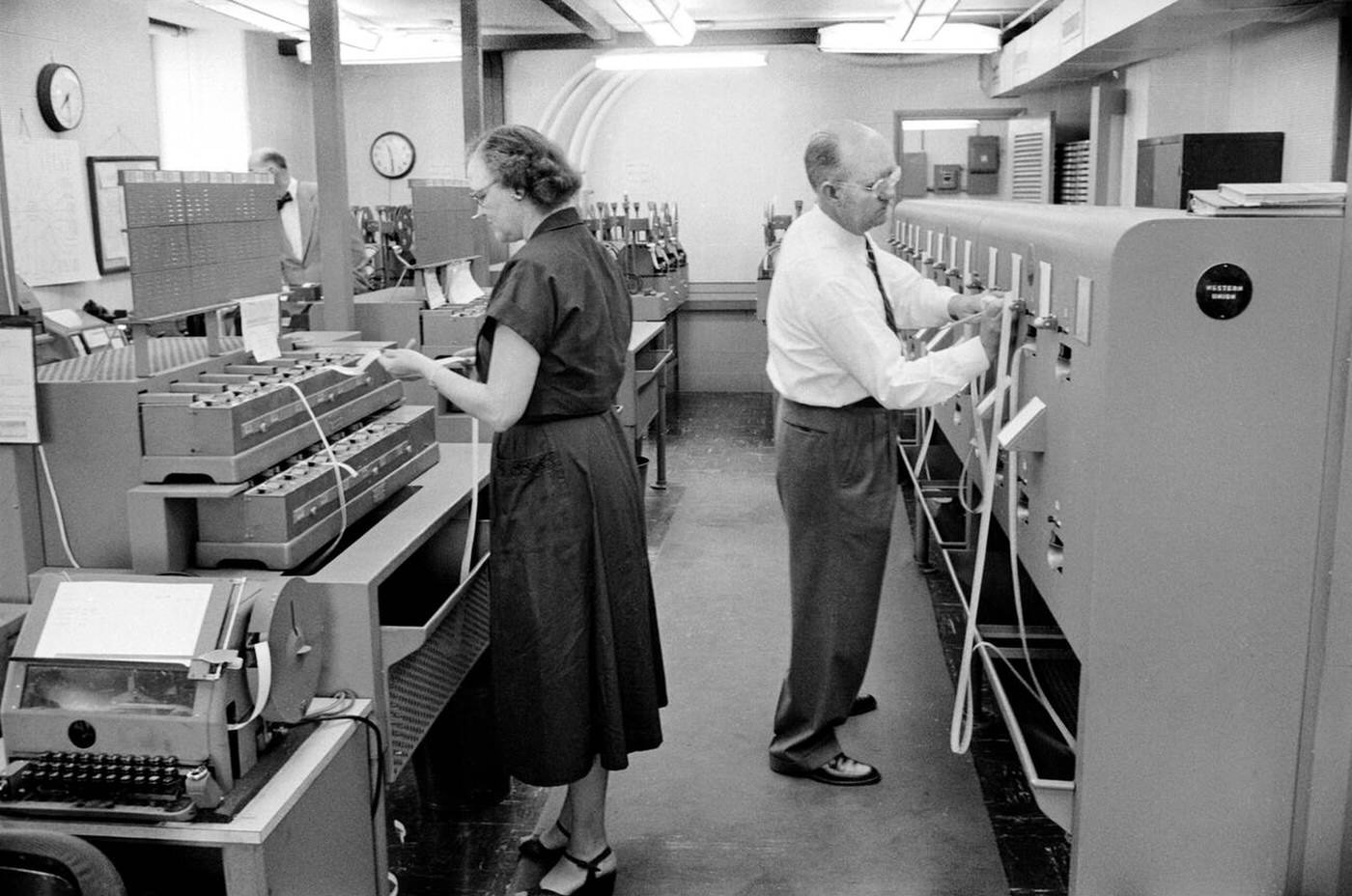 Two State Department Employees in the Teletype Room of Communications Center, Washington, D.C., 1956.
