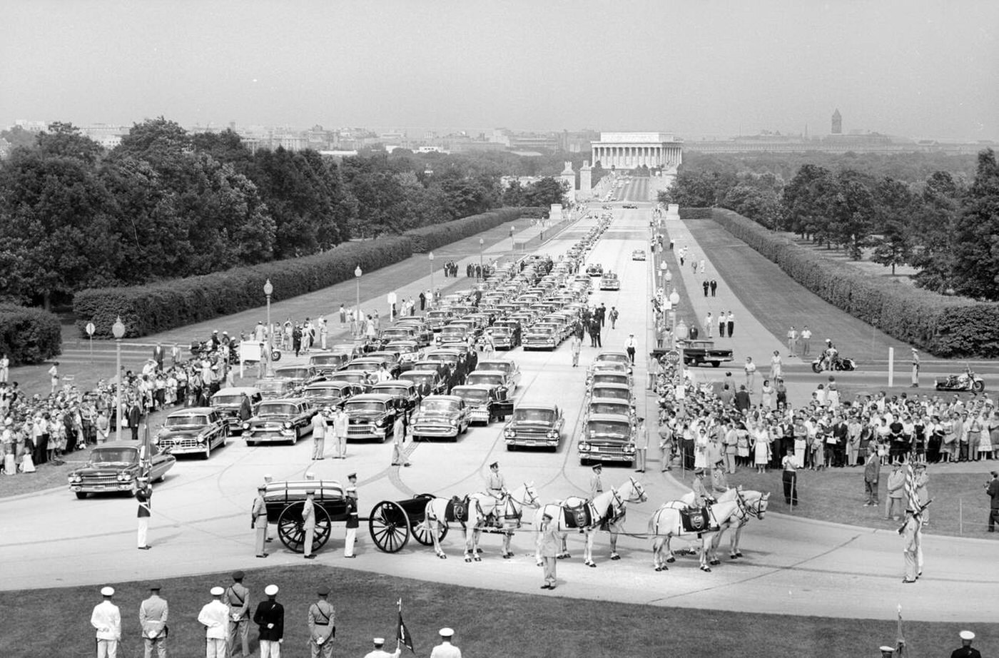 Funeral Procession and Flag-draped casket of U.S. Secretary of State John Foster Dulles on horse-drawn caisson at entrance to Arlington National Cemetery, Arlington, Virginia, 1959.