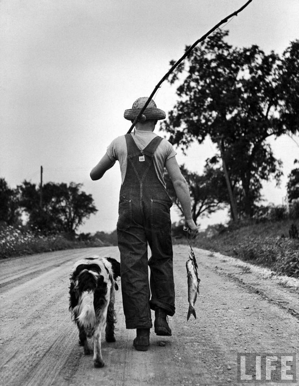 Off for home, Larry and Dunk trudge down the country road with a good-enough mess of fish.