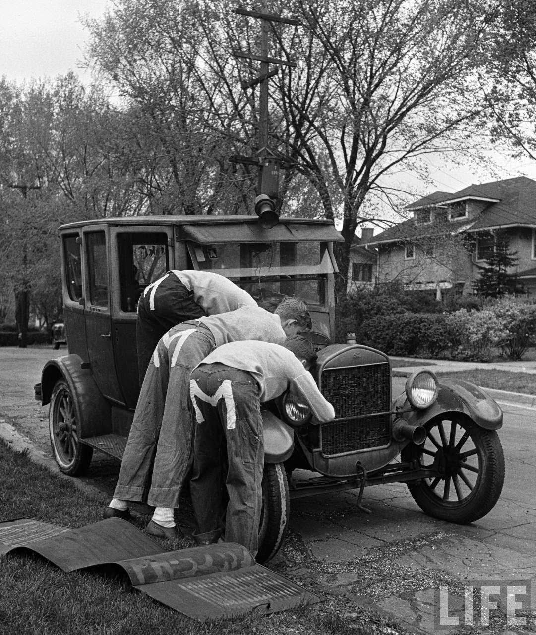 Teenaged boys working on a 1927 Ford Model T.