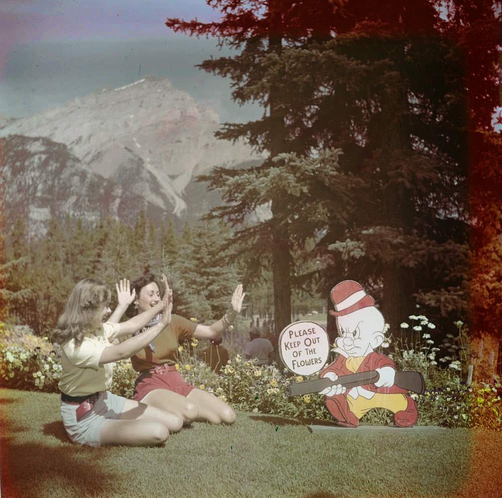 Women posing with an Elmer Fudd sign in the gardens of the Administration Building, 1951.