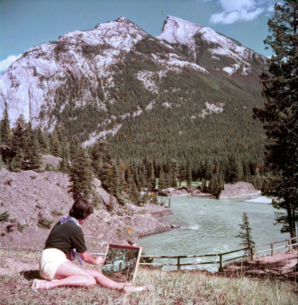 A woman paints near the Bow River, 1953.
