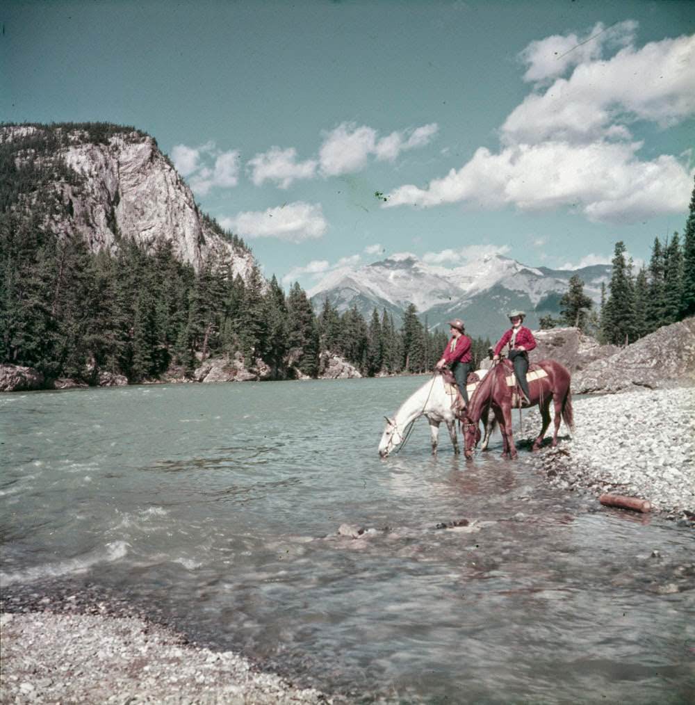 Riders pause on the banks of the Bow River, 1953.