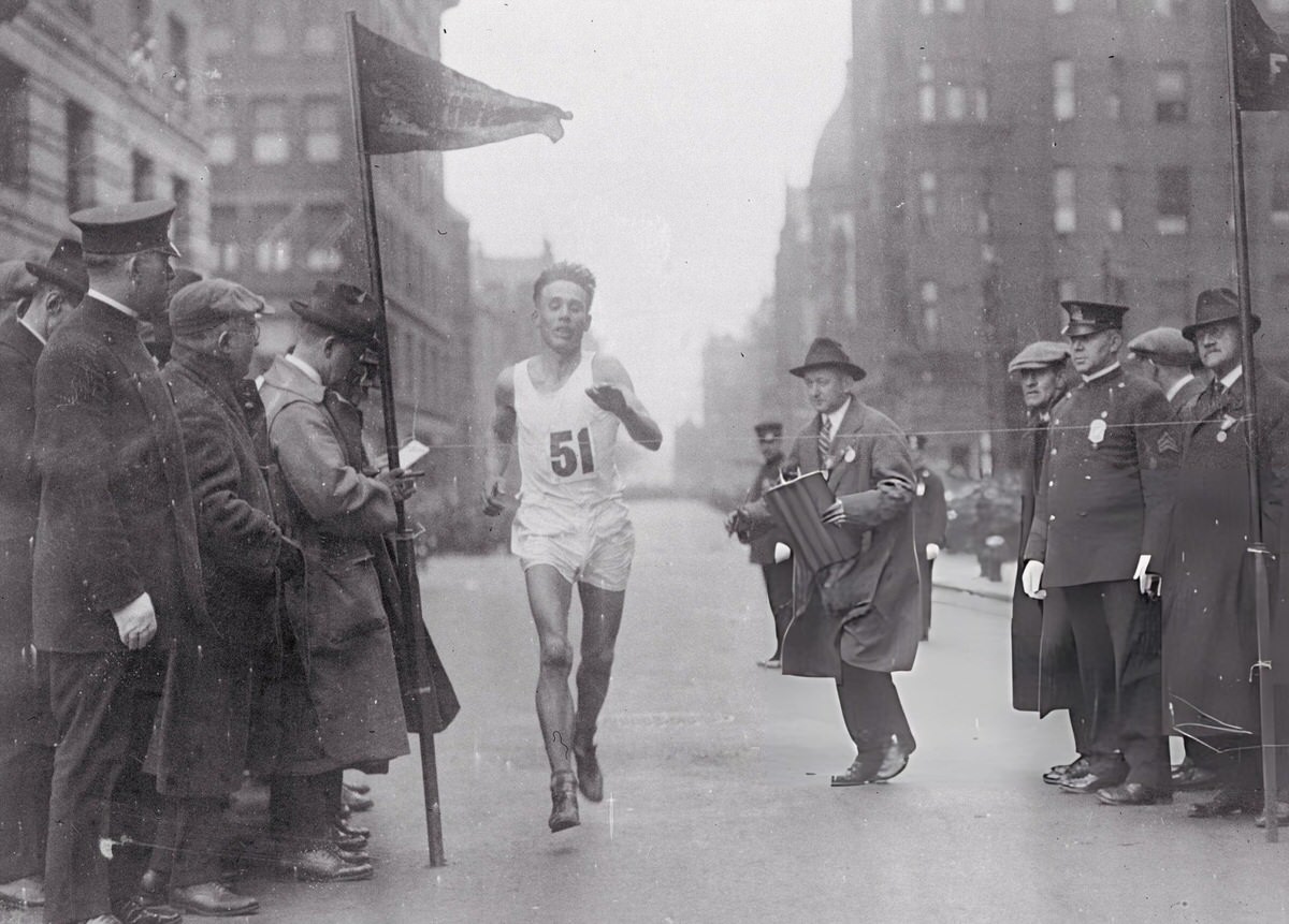 Willie Ritola crossing a finish line during the Boston Marathon, 1920s