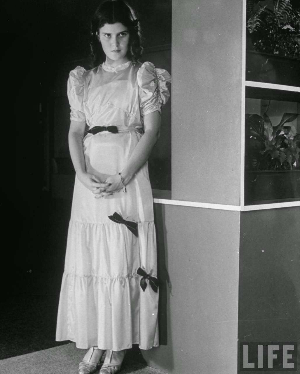 Her dress is too short and the neck is too high.