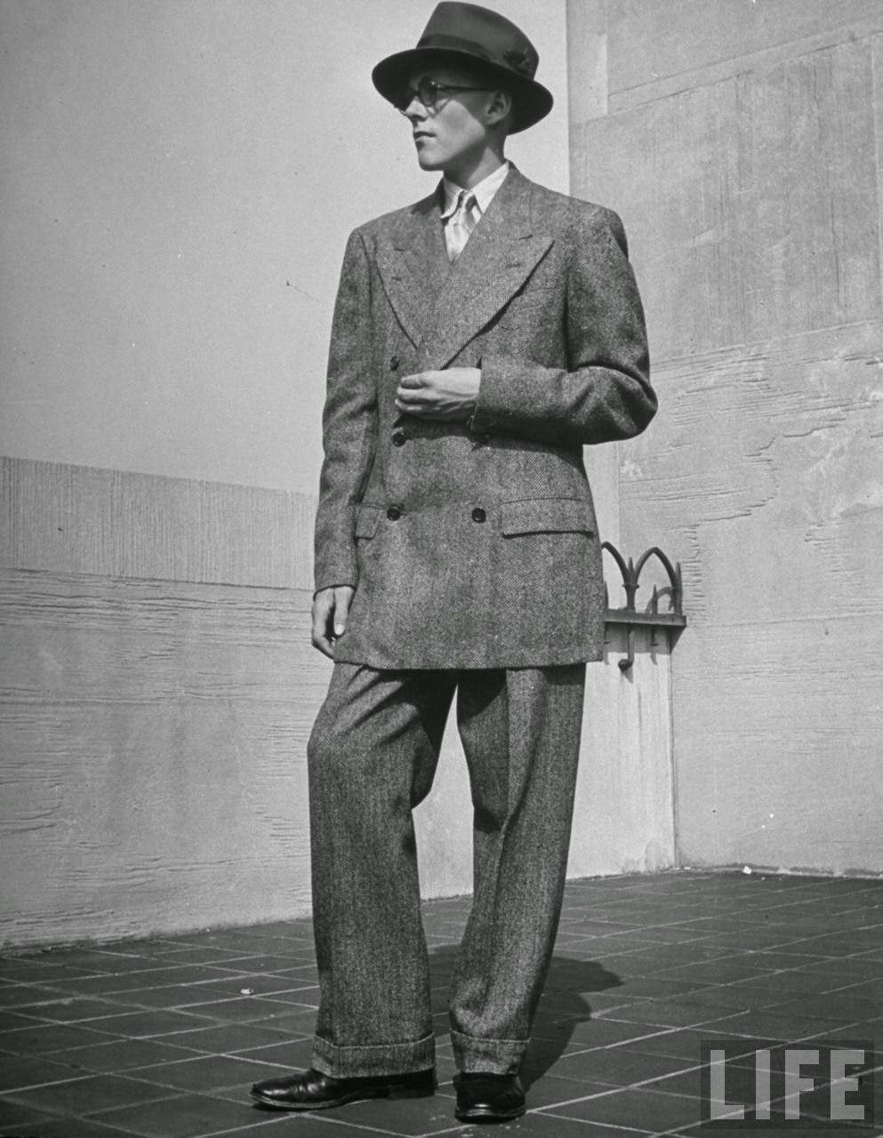 Double-breasted jacket, exaggerated shoulders, broad lapels, man's hat, make him look lile dad but they're bad.