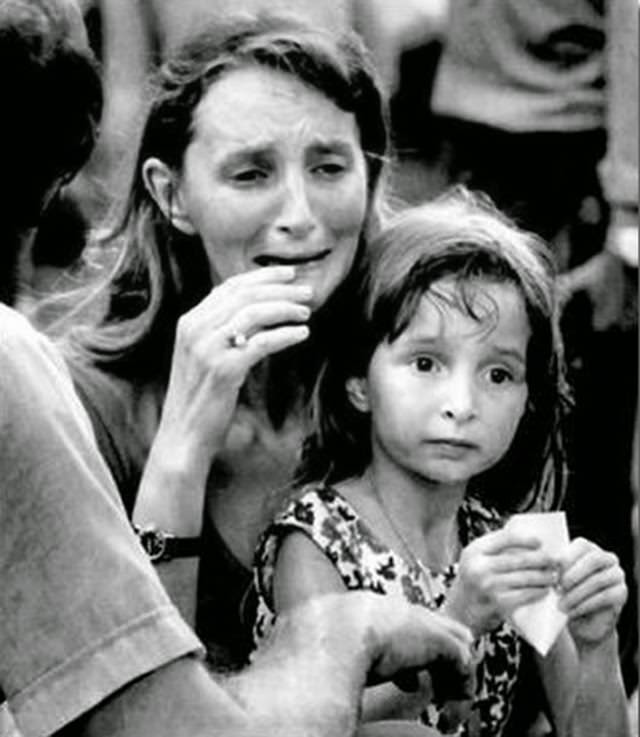 Arleen Miller, of Nebraska, breaks into a sob outside Elvis Presley's Graceland Mansion in Memphis.