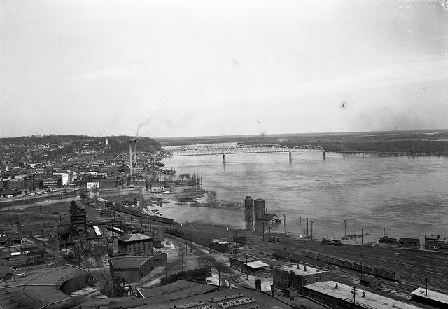 View of riverfront in Hannibal, Missouri, showing flooding and a bridge in the background, 1951