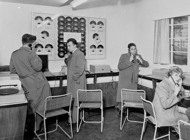 Customers using listening posts, 1950s