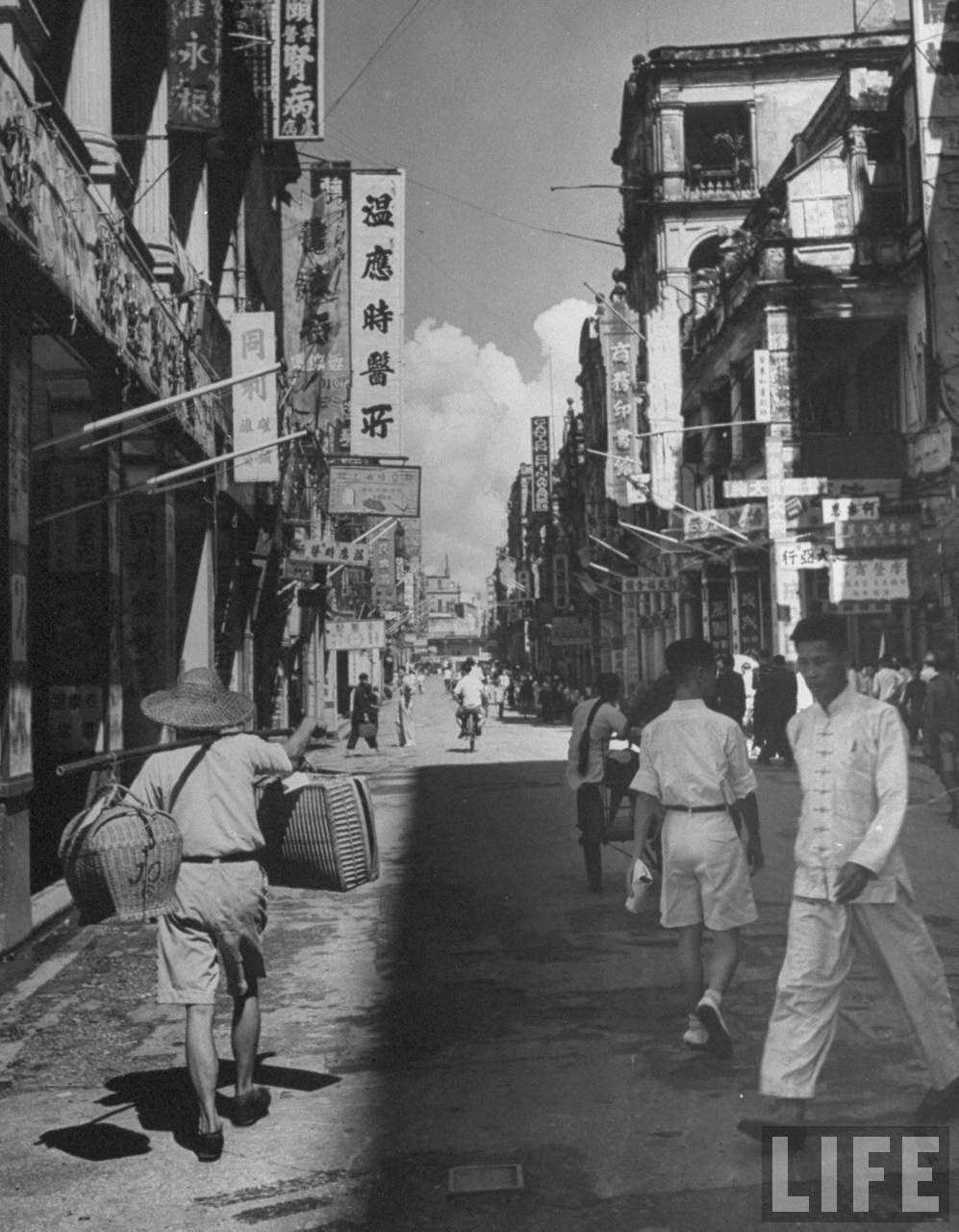 Pedestrians walking down Queen's Road.