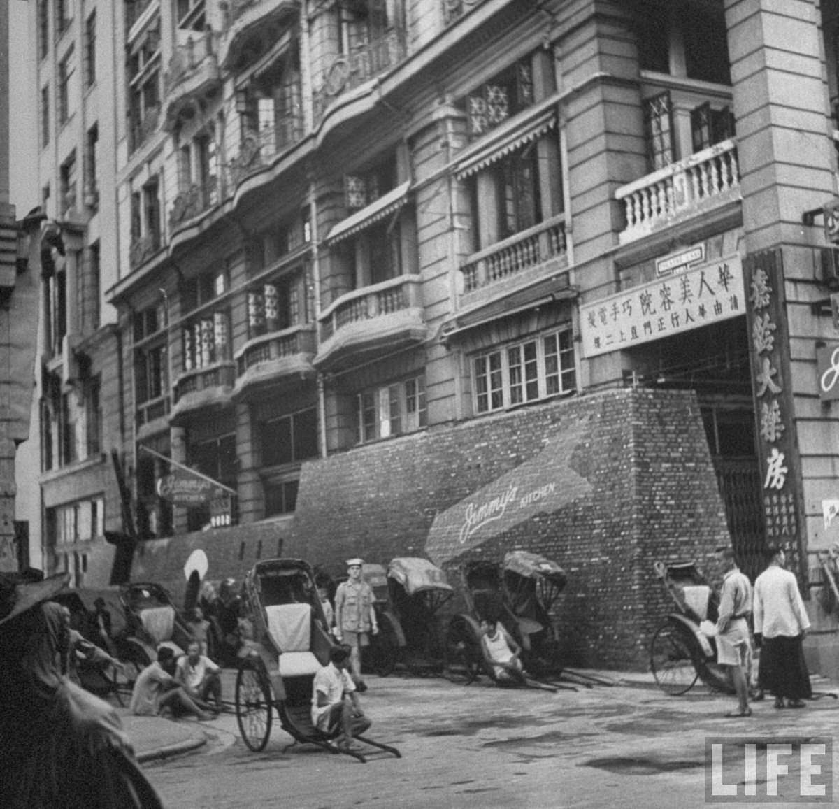 Rickshaws and their drivers awaiting fares on Theatre Lane.