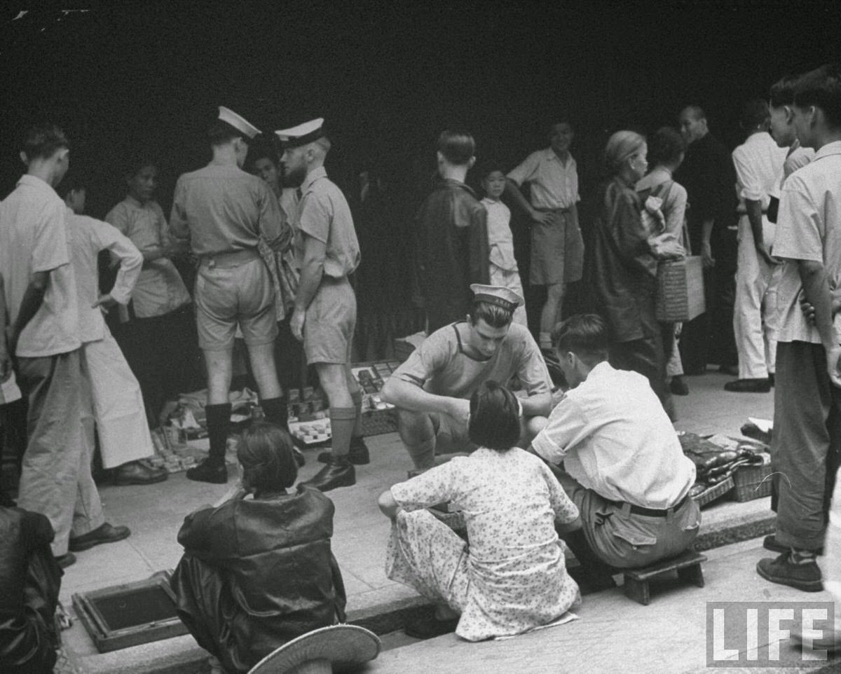 Members of Royal Navy and Royal Marines shopping at an open air market on Queen's Road.