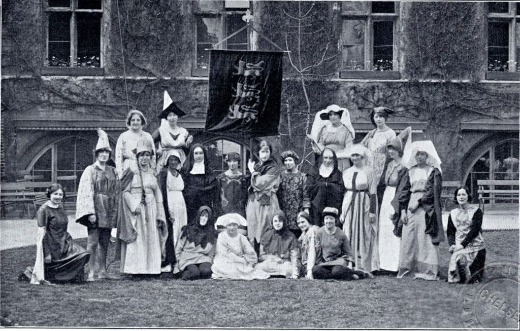 The masque here looks like an amateur theatrical event, or a fancy dress party, 1922.