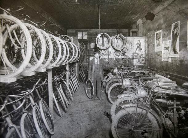 Aaron Morris stands in his bicycle and motorcycle repair shop in Elizabeth, New Jersey, 1900s