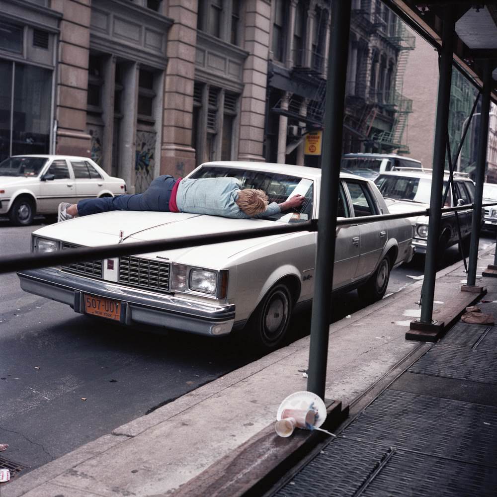 Man asleep on car, 1985