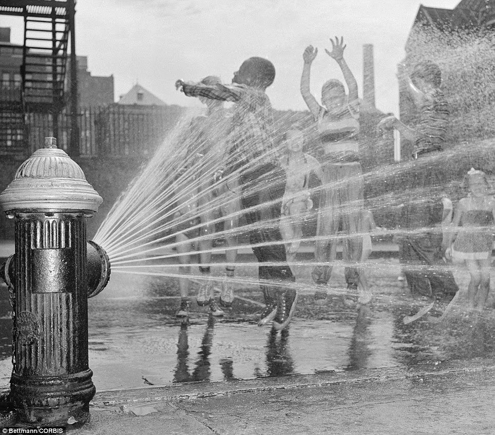 Children welcomed sweltering weather in 1954 because it gave them a chance to frolic under the spray of fire hydrants; pictured, near New York City's Columbus Circle