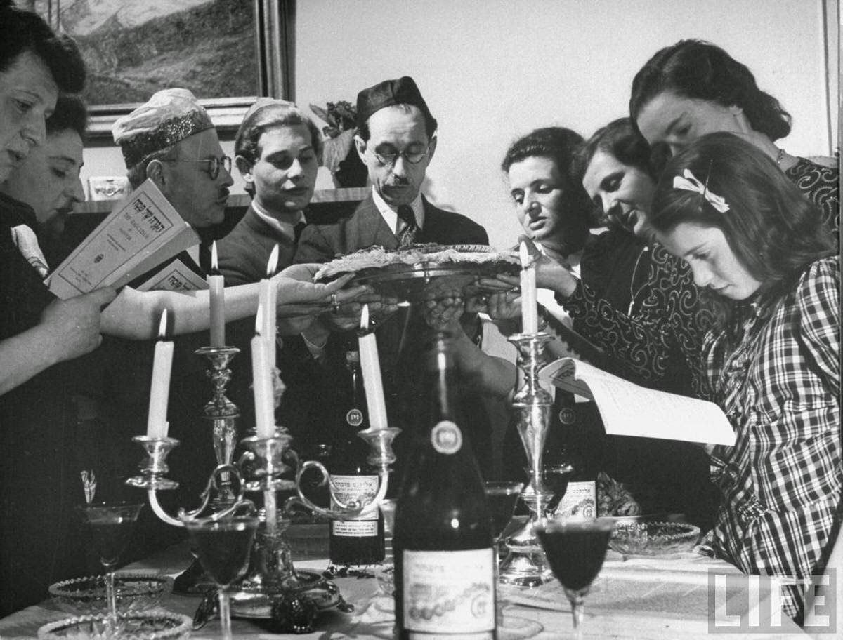 Tasting bitter herbs, symbolizing hardships of ancient Jews in Egyptian slavery, during the Passover seder.