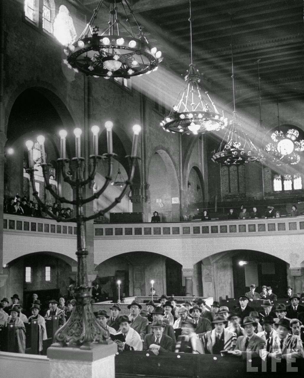 Jewish congregation observing synagouge services during Passover.