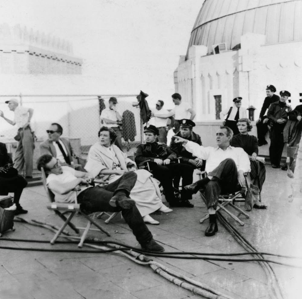 Between takes, Dean slouches in his chair with his on-screen parents Jim Backus and Ann Doran (who play Mr and Mrs Stark) and a cast of cops at Griffith Observatory.