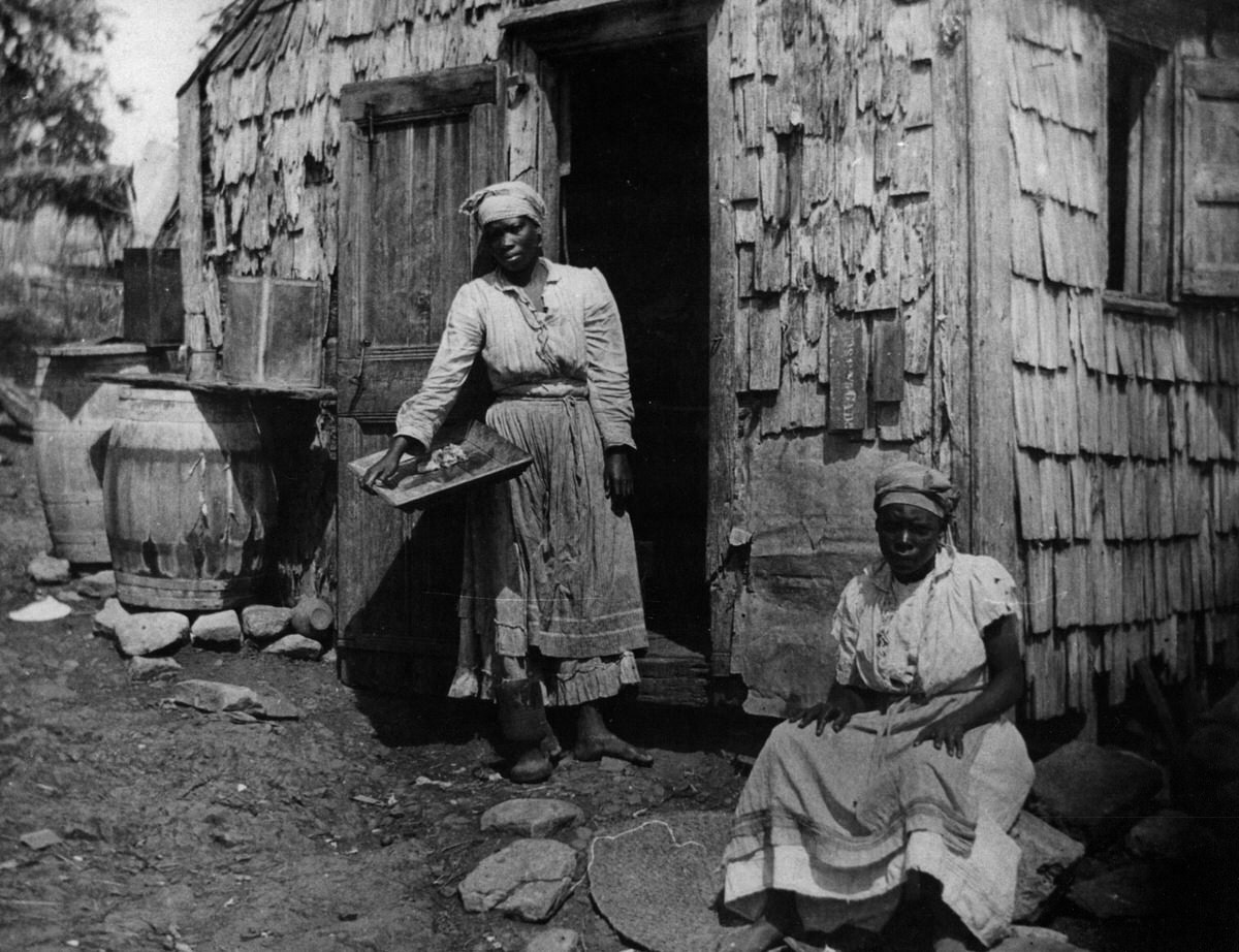 Two women in front of a house at St. Croix
