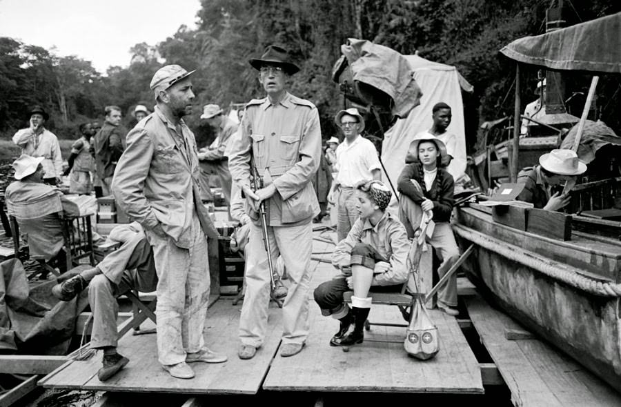 Humphrey Bogart and director John Huston joined on the set by Lauren Bacall and crew members during filming of The African Queen.