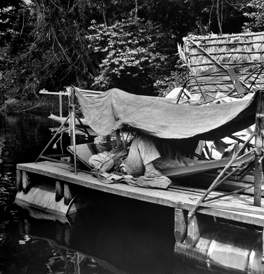 Bogart snoozes in a hammock under makeshift shelter on an equipment raft. He never had to study lines, learned them after two or three readings.