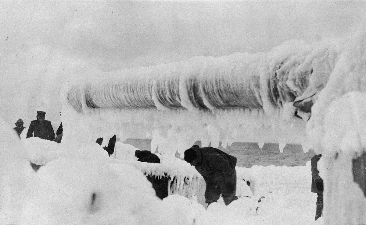 Men on deck of a ship removing ice while on a winter morning returning from France, 1918.
