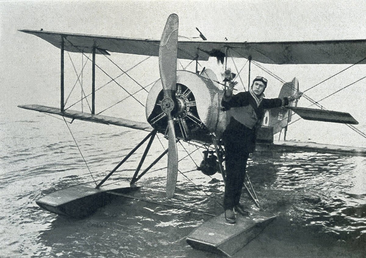 A British military person releases a carrier pigeon from a British seaplane in the North Sea during World War I, 1918.